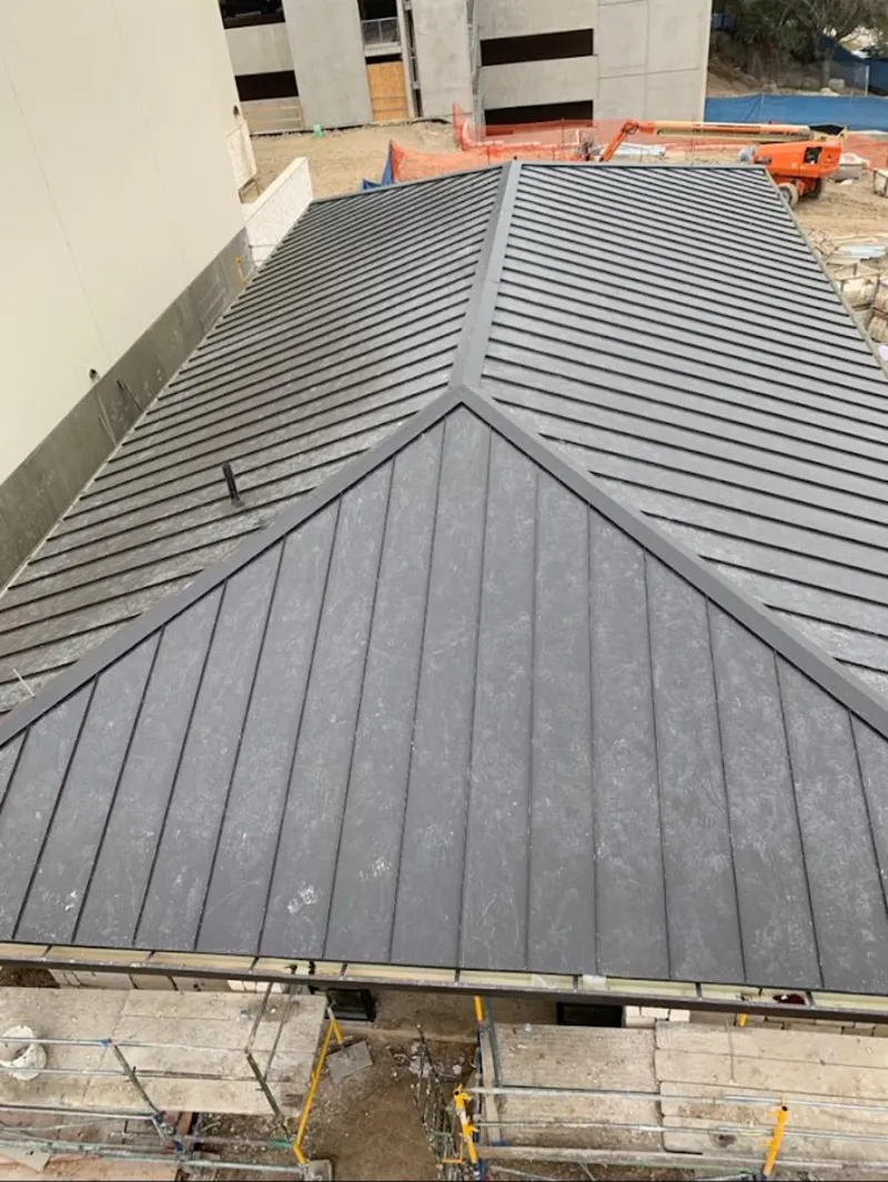 Commercial metal roof construction with crane equipment in Ramapo